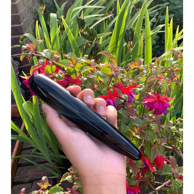 girl holding black obsidian yoni crystal wand